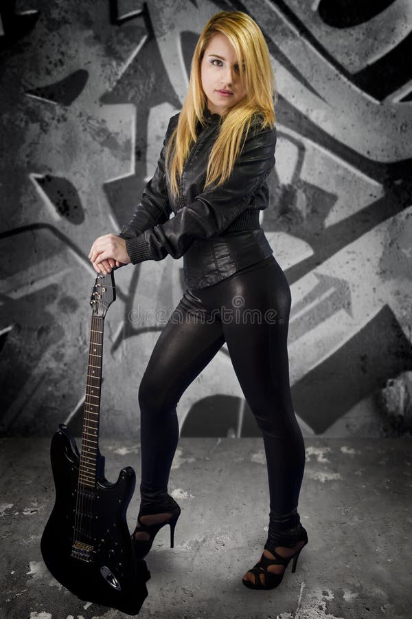 young blonde dressed in black leather with electric guitar