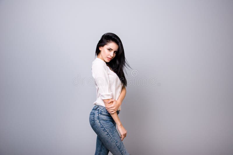 young brunette in casual outfit is looking flirty and hugs royalty free stock photos young brunette in casual outfit is looking flirty and hugs royalty free stock photos