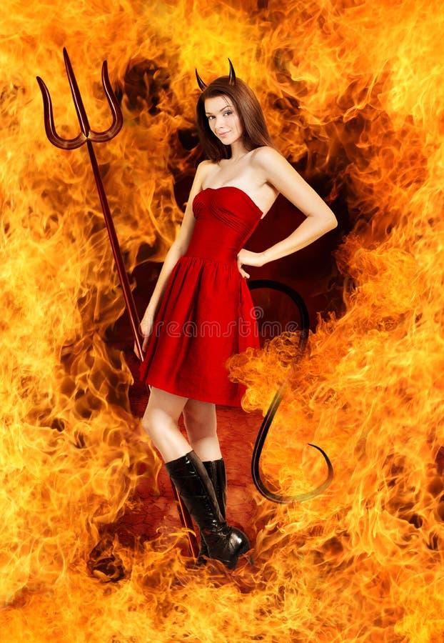young brunette woman as devil in fire with horns, trident and tail