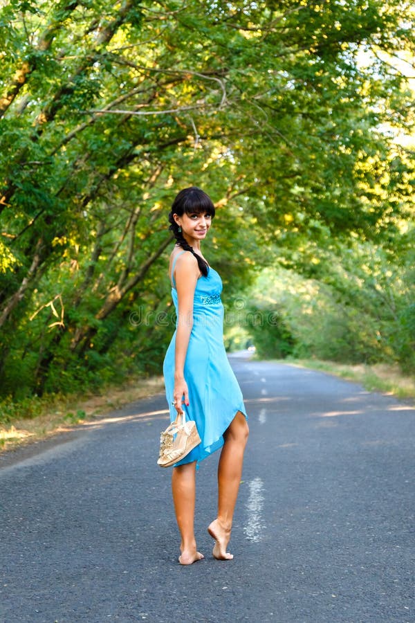 Young Brunette Woman Walking on Empty Road at Summer Da Stock Photo ...