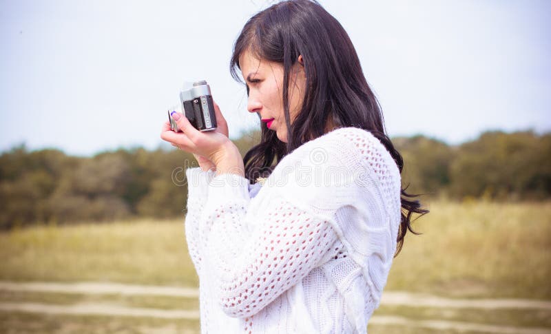 Young Girl in Knitted with a Camera Clothes Outdoor Portrait Stock Photo amateur 800x485 image Young Girl in Knitted with a Camera Clothes Outdoor Portrait Stock Photo