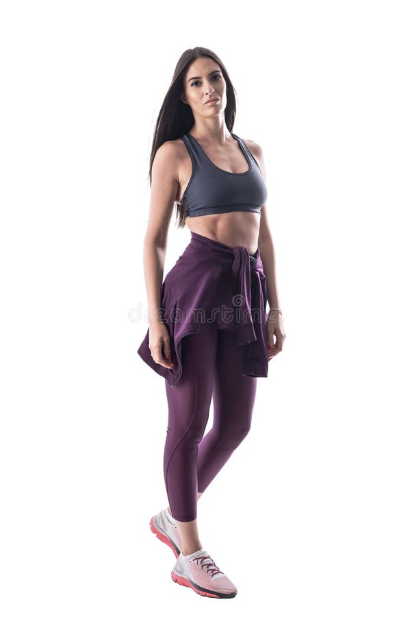 Premium Photo  Sexy pretty fitness model girl with a beautiful slim body  in fashionable workout clothes with purple leggings, tank top and shoes  poses in the city