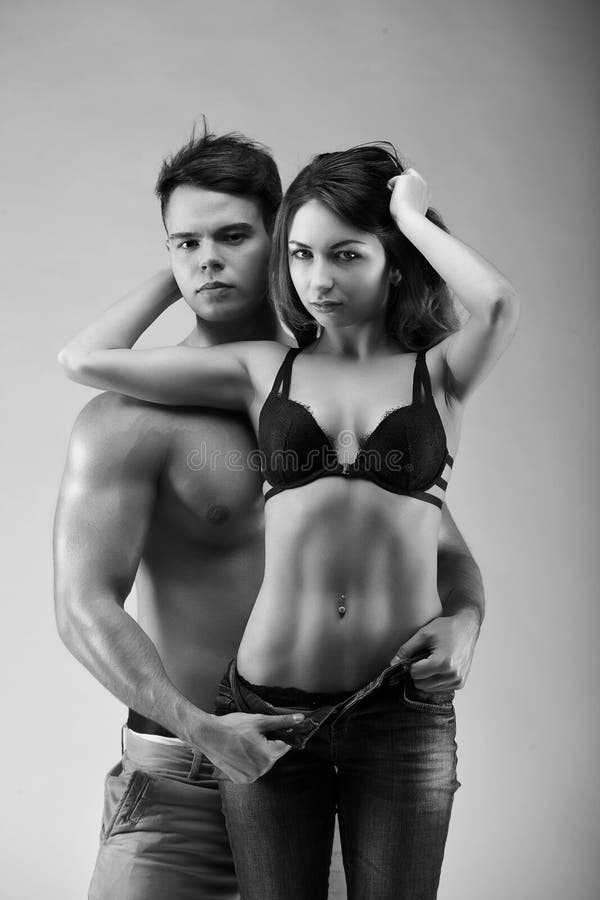Sexynaked couple of muscular boy in underwear and girl undressing. 