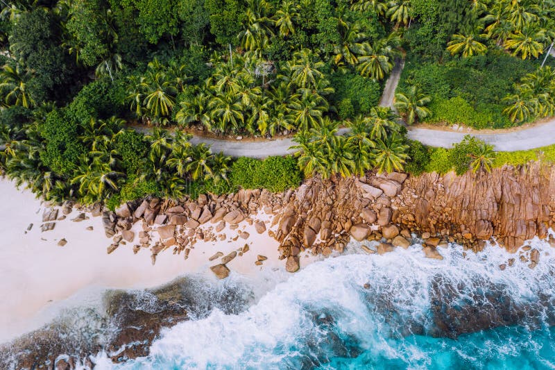Seychelles Mahe island aerial drone landscape of coastline. Road along coastline of paradise sandy beach with palm trees stock image Seychelles Mahe island aerial drone landscape of coastline. Road along coastline of paradise sandy beach with palm trees stock image