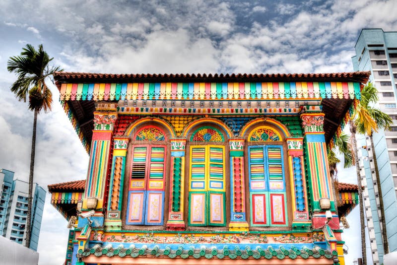 HDR rendering of a colorful building facade in Little India, Singapore, with tall high-rise apartments in the background. A stark contrast of the old and new living quarters in Singapore. HDR rendering of a colorful building facade in Little India, Singapore, with tall high-rise apartments in the background. A stark contrast of the old and new living quarters in Singapore.