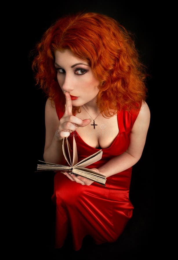 Redhead religious lady with finger on lips. Redhead religious lady with finger on lips