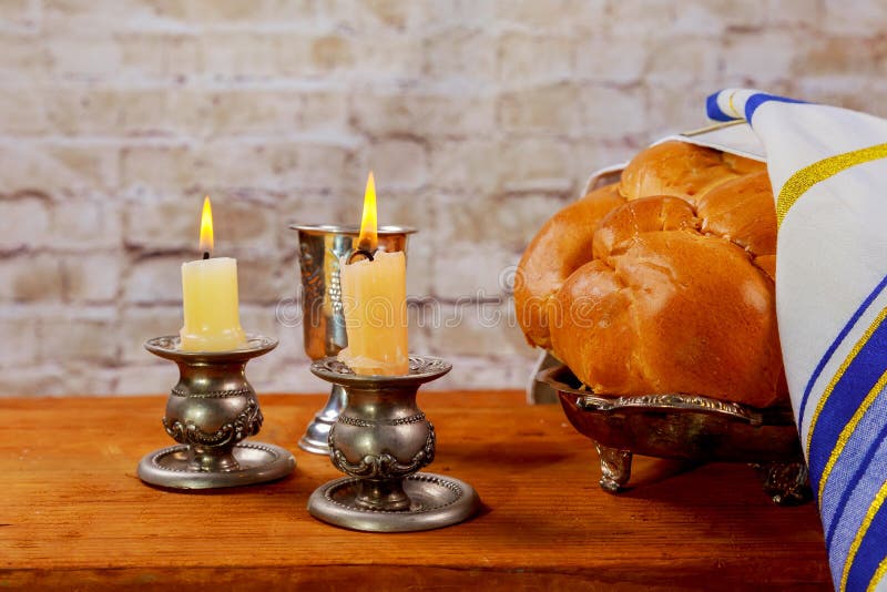 Shabbat Candles in Glass Candlesticks with Blurred Covered Challah