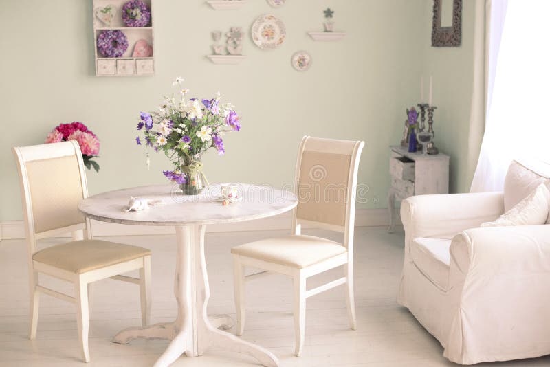 Shabby chic dining room interior with flowers decorative plates