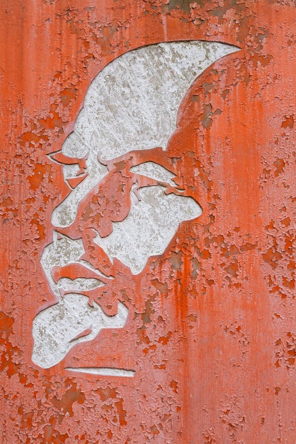 Shabby white silhouette of Lenin on a red background