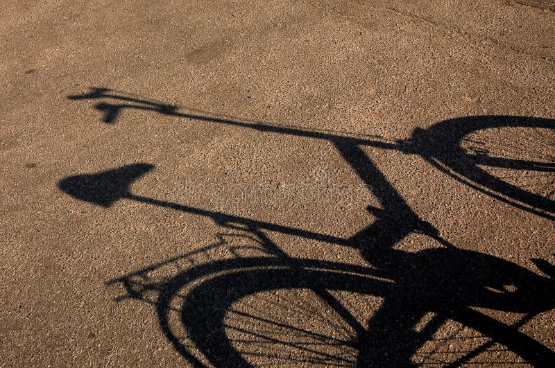 Shade of a bicycle on a asphalt.