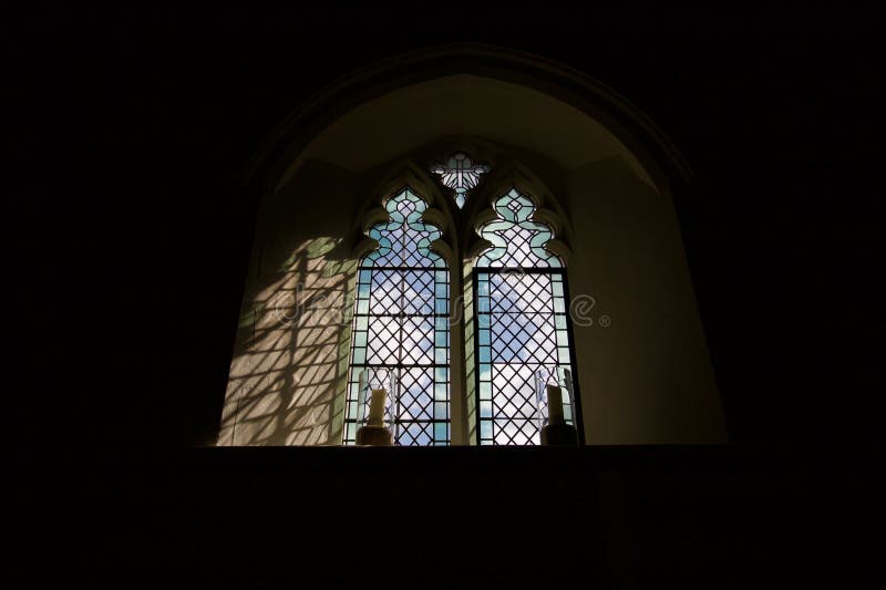 Light shining through Christian church glass window