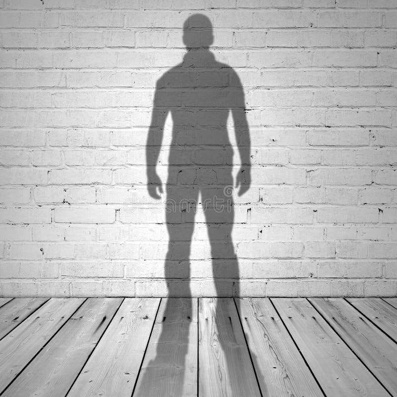 Shadow of a man on white brick wall