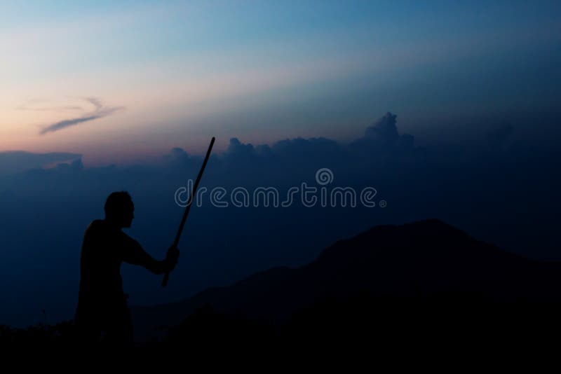 Shadow of Samurai with Sword Practice Fencing and Beautiful Mountain