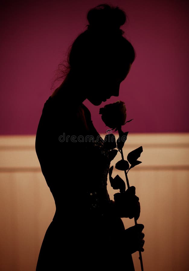 Shadow of woman holding a rose