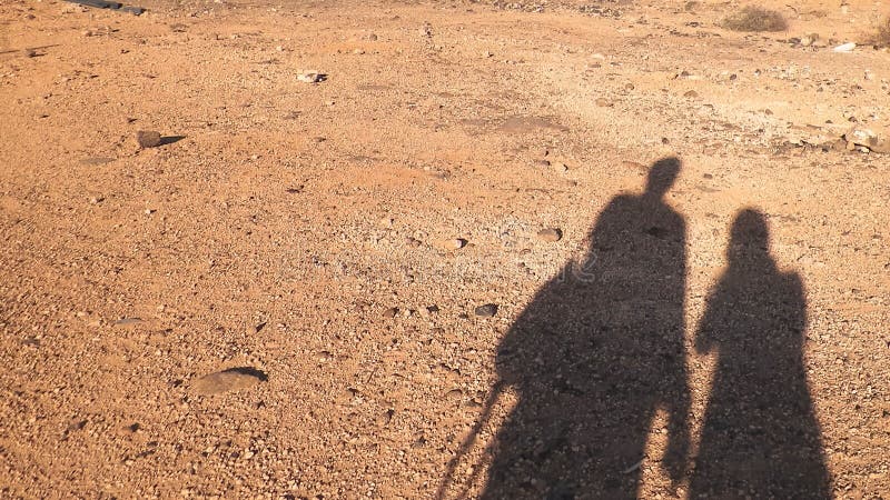 Shadows of couple of travelers on desert. royalty free stock images Shadows of couple of travelers on desert. royalty free stock images