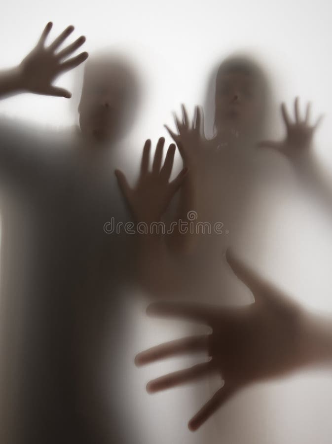 Shadows of people behind transparent paper royalty free stock photo