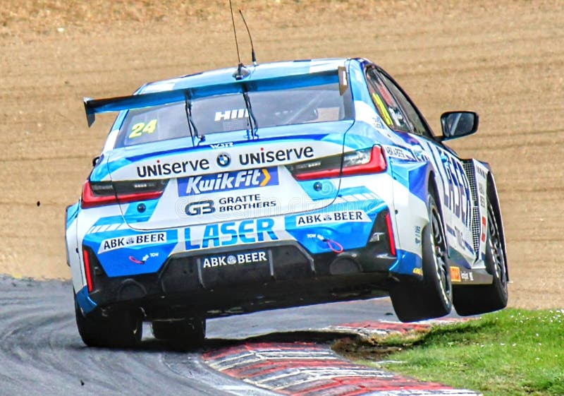 BMW British Touring Car shakedown at Brands Hatch, two wheels at Paddock Hill bend.