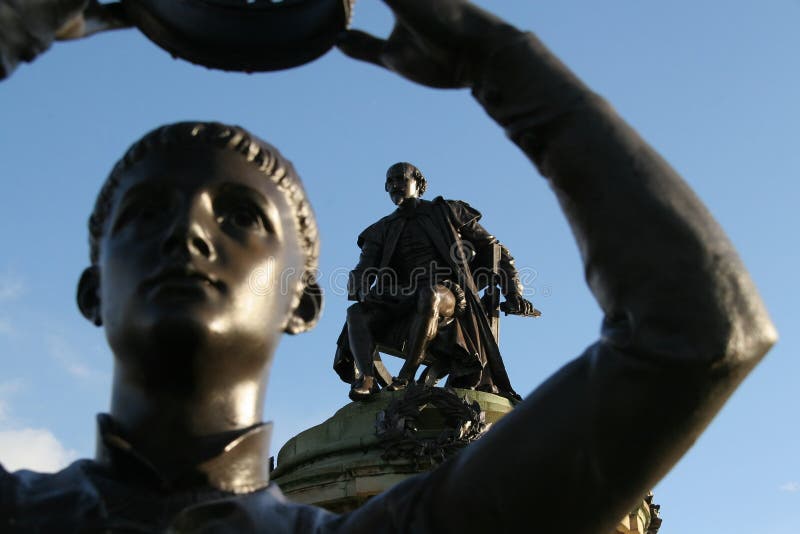 The Shakespeare statue at Stratford shows through the arm of the Prince Hal (from Henry V) statue at the same location. The Shakespeare statue at Stratford shows through the arm of the Prince Hal (from Henry V) statue at the same location.