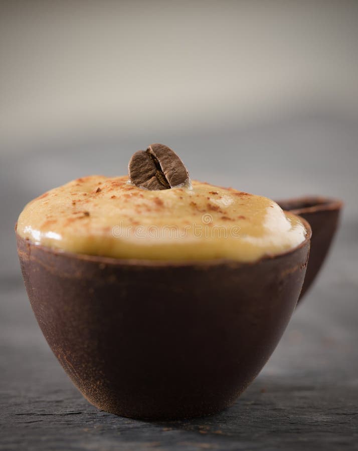 Shallow coffee mousse in a dark chocolate cup