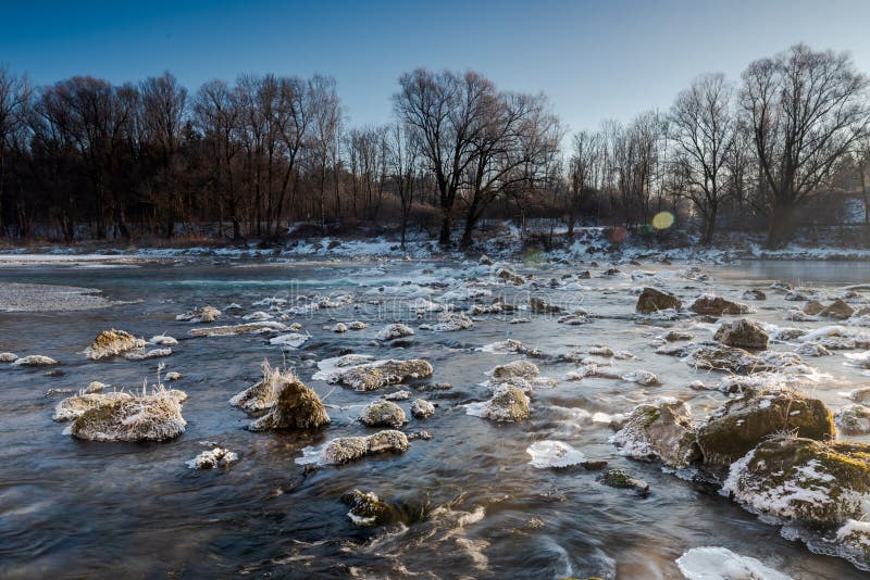 Shallow Spot of the River Isar in Munich with Ice on Rocks on a Cold