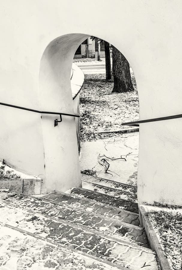 Shallow stairs and an historic gate with railing, colorless