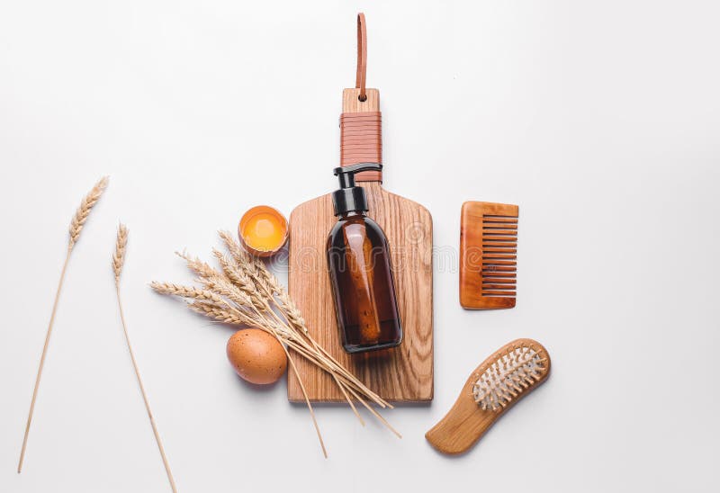 Shampoo with Natural Extract, Comb and Brush on White Background Stock