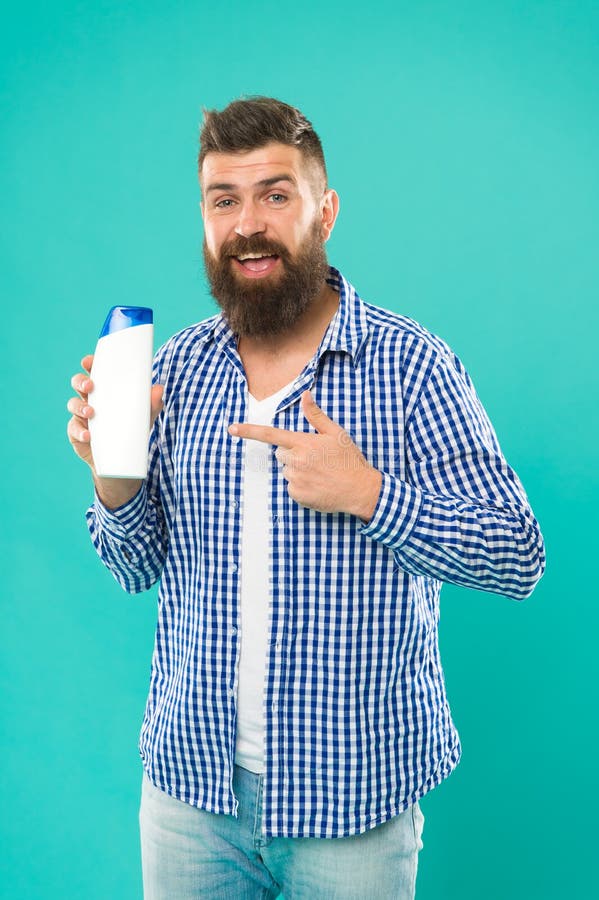 Shampoo for daily use. Body care cosmetic bath shower. Man hold shampoo bottle. Hair care. Skin lotion. Shampoo and stock photo Shampoo for daily use. Body care cosmetic bath shower. Man hold shampoo bottle. Hair care. Skin lotion. Shampoo and stock photo