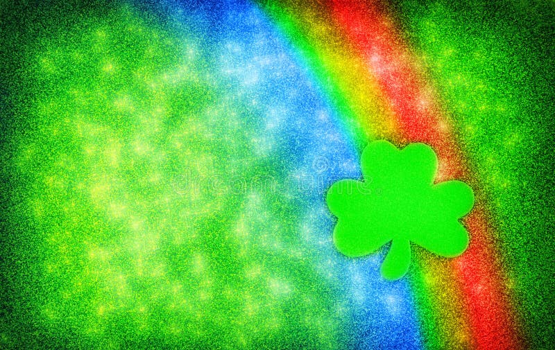 A simple Saint Patrick's Day background constructed out of Glitter featuring rainbow colors and a single Shamrock shape. A simple Saint Patrick's Day background constructed out of Glitter featuring rainbow colors and a single Shamrock shape.