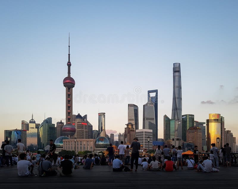 Shanghai, China - Aug 14 2016: Pudong New Area skyline. People enjoying sunset from the Bund. stock image Shanghai, China - Aug 14 2016: Pudong New Area skyline. People enjoying sunset from the Bund. stock image