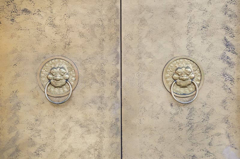 Two lion-shaped metal knockers on a Chinese door stock photography Two lion-shaped metal knockers on a Chinese door stock photography