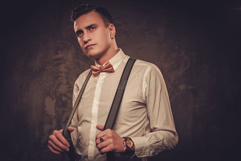 Sharp dressed man wearing suspenders and bow tie