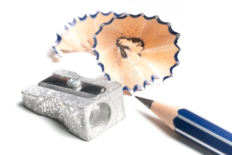 Sharp Pencil, Pencil Sharpener and Shavings on White Desk Stock Photo