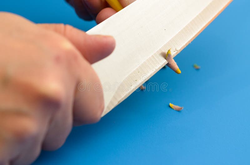 Sharpen the Colored Pencils with a Knife. Stock Image Image of black