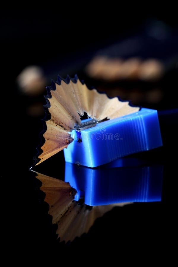 Photograph of a pencil being sharpened with more pencils in the background. Photograph of a pencil being sharpened with more pencils in the background.