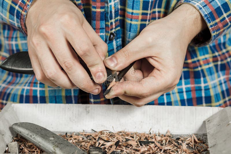 Sharpening a Pencil with a Stationery Knife. Stock Image Image of