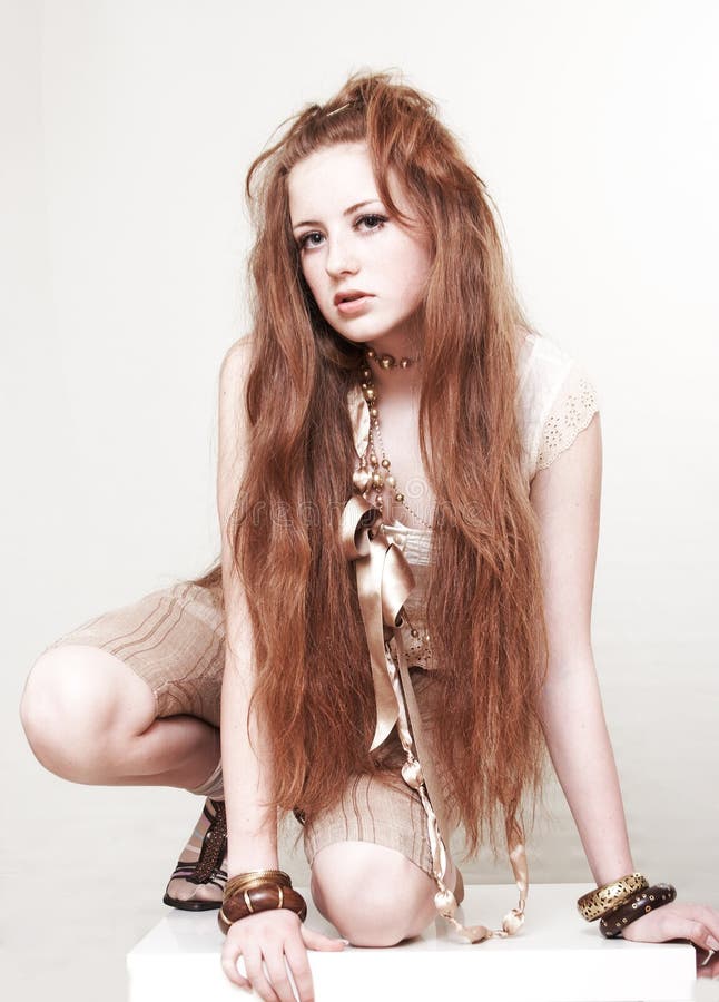 A girl with red hair. The photo is on a white background in warm tones. Lovely european female stock images, royalty-free photos and pictures