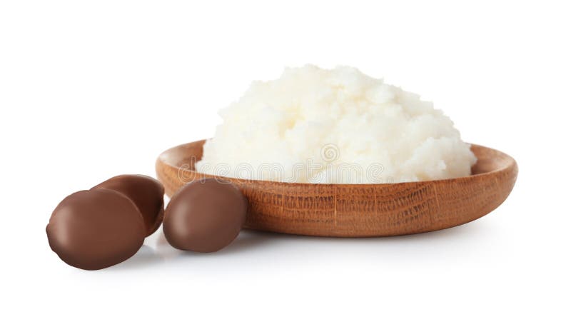 Shea butter in bowl and nuts on white royalty free stock photo