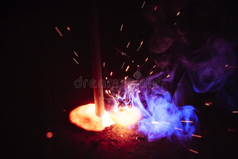 A Sheaf of Sparks Caused by a Welding Arc. Semiautomatic Welding Work