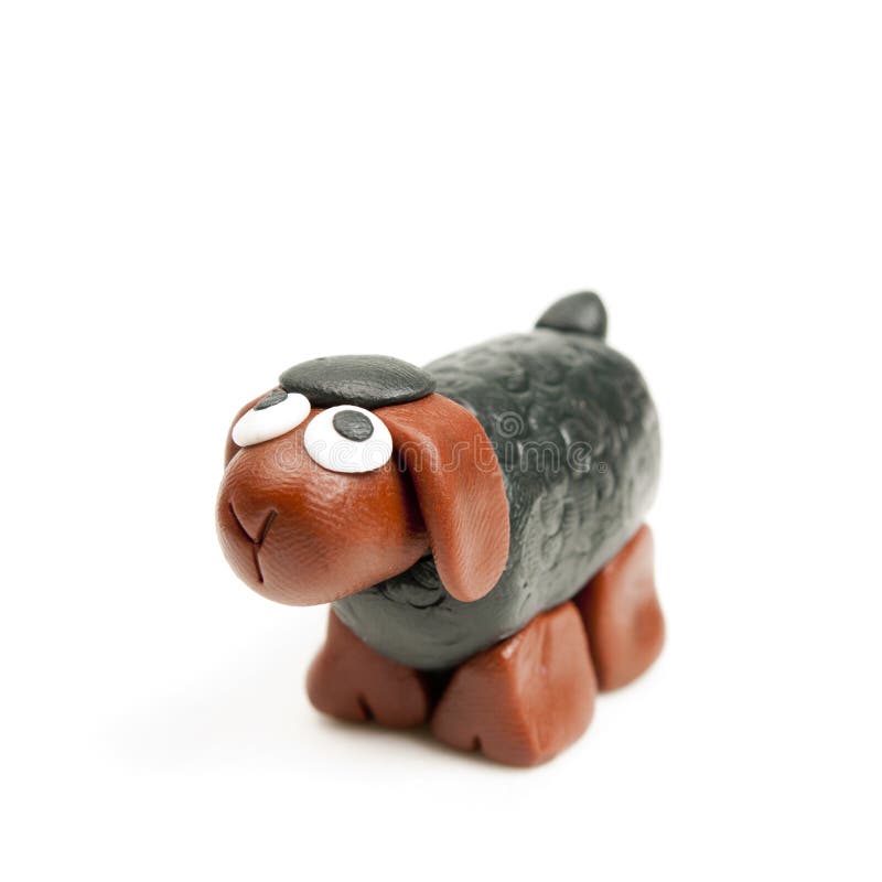Polymer clay miniature black sheep looking up. Polymer clay miniature black sheep looking up