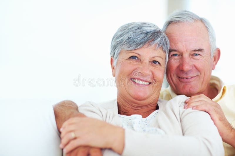 Sheer Joy Closeup Of Cheerful Mature Couple Laughing Together While Sitting At Home Stock