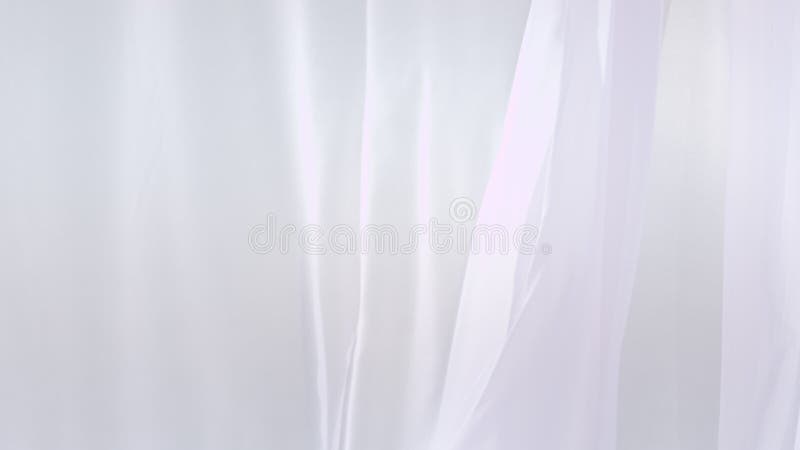 Sheer white curtains blowing in the wind