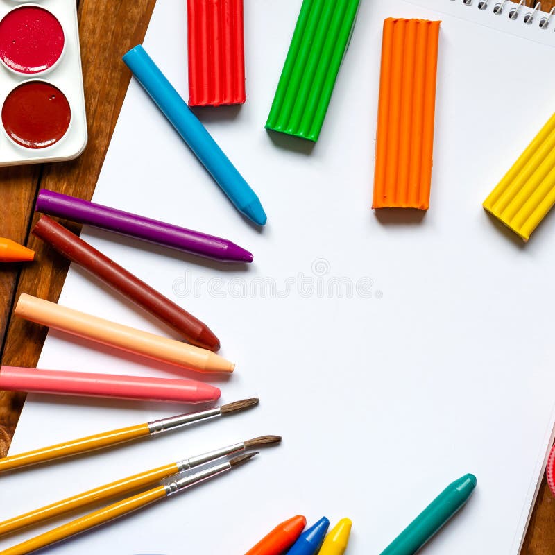 Creative workshop for kids. Scissors and a pile of sharp coloured drawing  pencils on table. Cutting