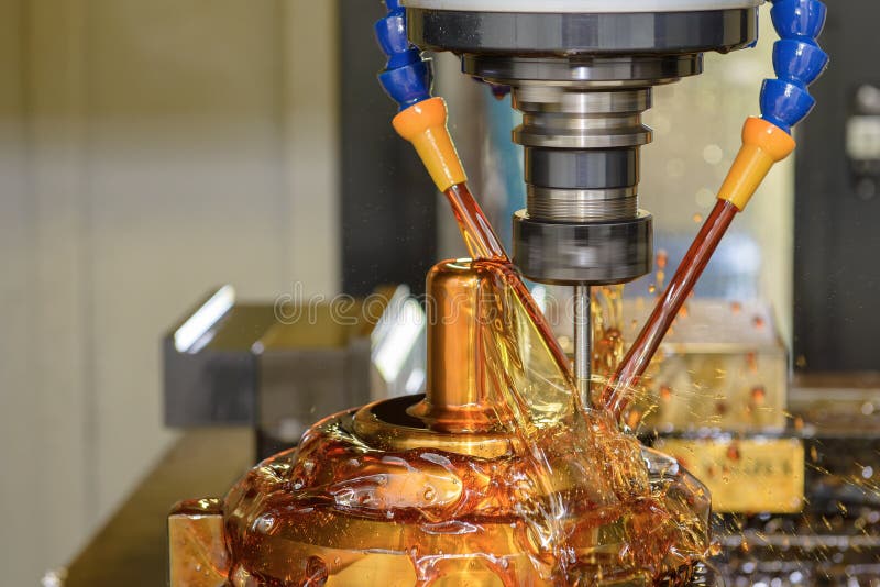 CNC Milling Machine Cutting Shell Mold with Ball Nose End Mill and Oil Coolant royalty free stock photo