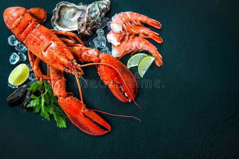 Shellfish plate of crustacean seafood with fresh lobster, mussels, shrimps, oysters as an ocean gourmet dinner background. Shellfish plate of crustacean seafood with fresh lobster, mussels, shrimps, oysters as an ocean gourmet dinner background