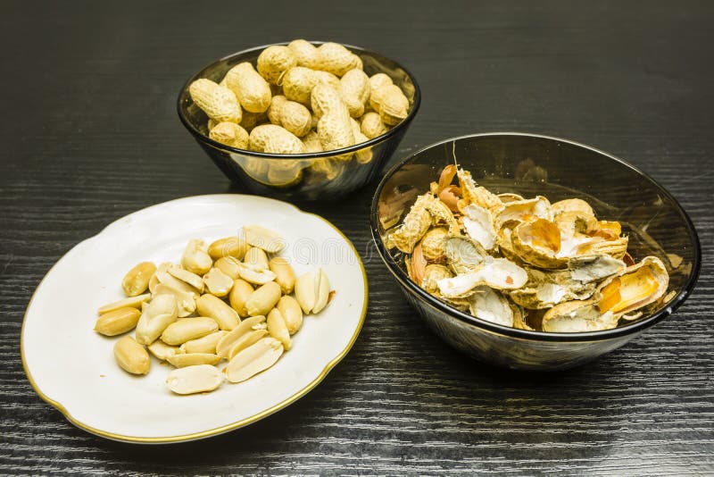 Peeling Peanuts. a Bowl of Peels and Clean Peanuts on the Plate. Stock