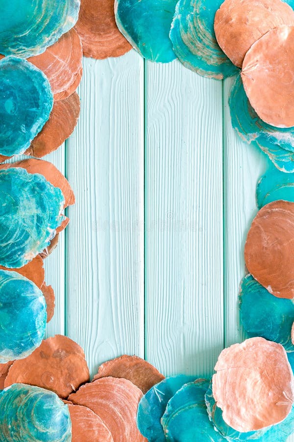 Shells frame for blog design on mint green wooden background top view space for text royalty free stock photos