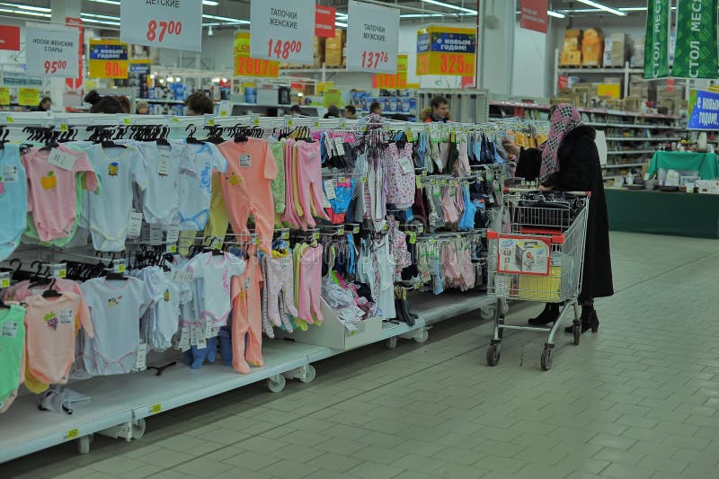 Shelves with baby clothes editorial photography. Image of infantile
