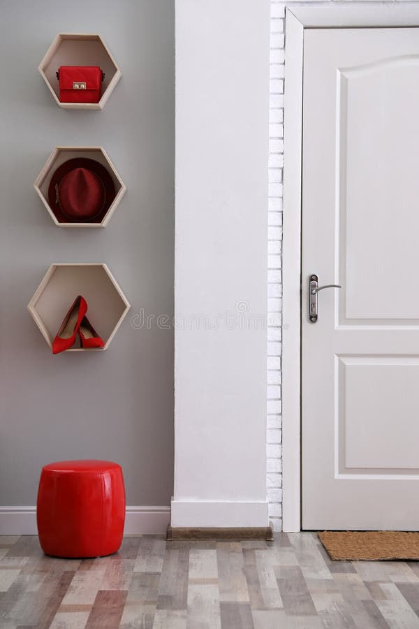 Shelves with Different Accessories on Wall in Hallway. Interior Design