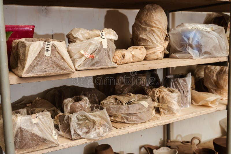 Shelves with Packages or Bags with Pieces of Clay until they are Fired