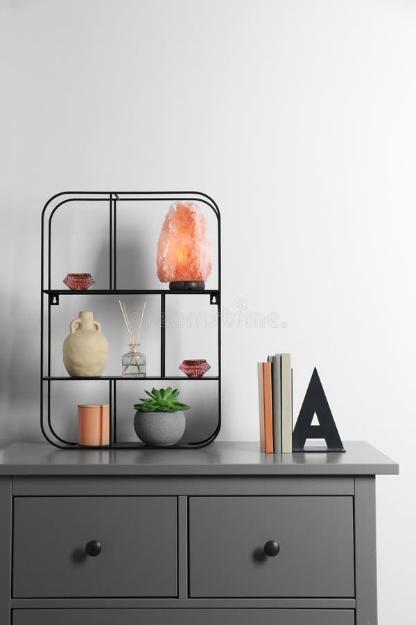 Shelving Unit with Decorative Elements and Books on Chest of Drawers